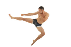 Excellent fight pose of intense man boxer with a kick in the air isolated over white background Jiu jitsu or kick box or thai boxing