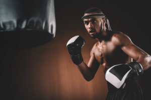 Determined Young Muay Thai Fighter In Boxing Gloves Training Tha